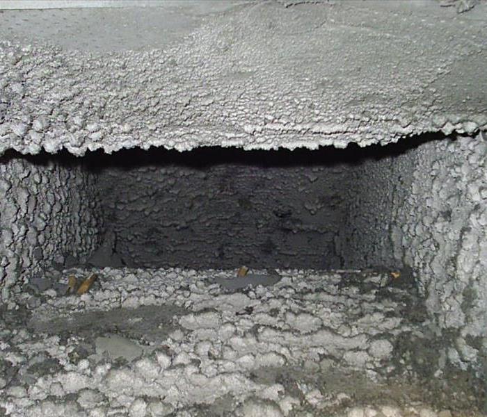 A picture of a dirt filled air duct 
